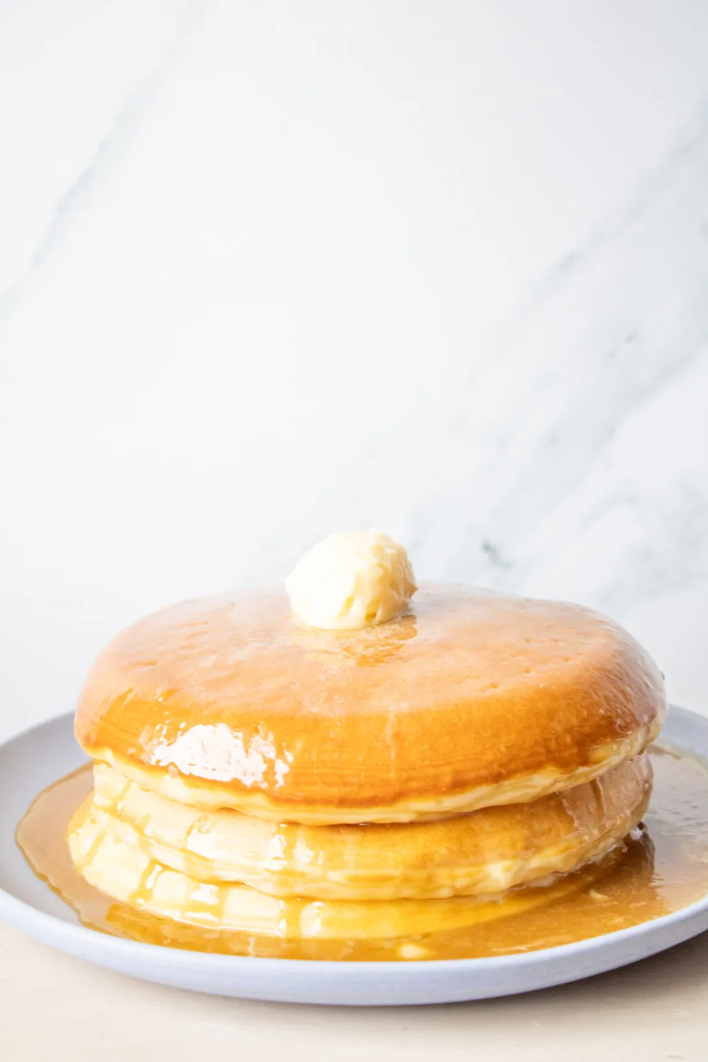 Extra thick fluffy pancake stack from Golden Diner NYC with melting butter