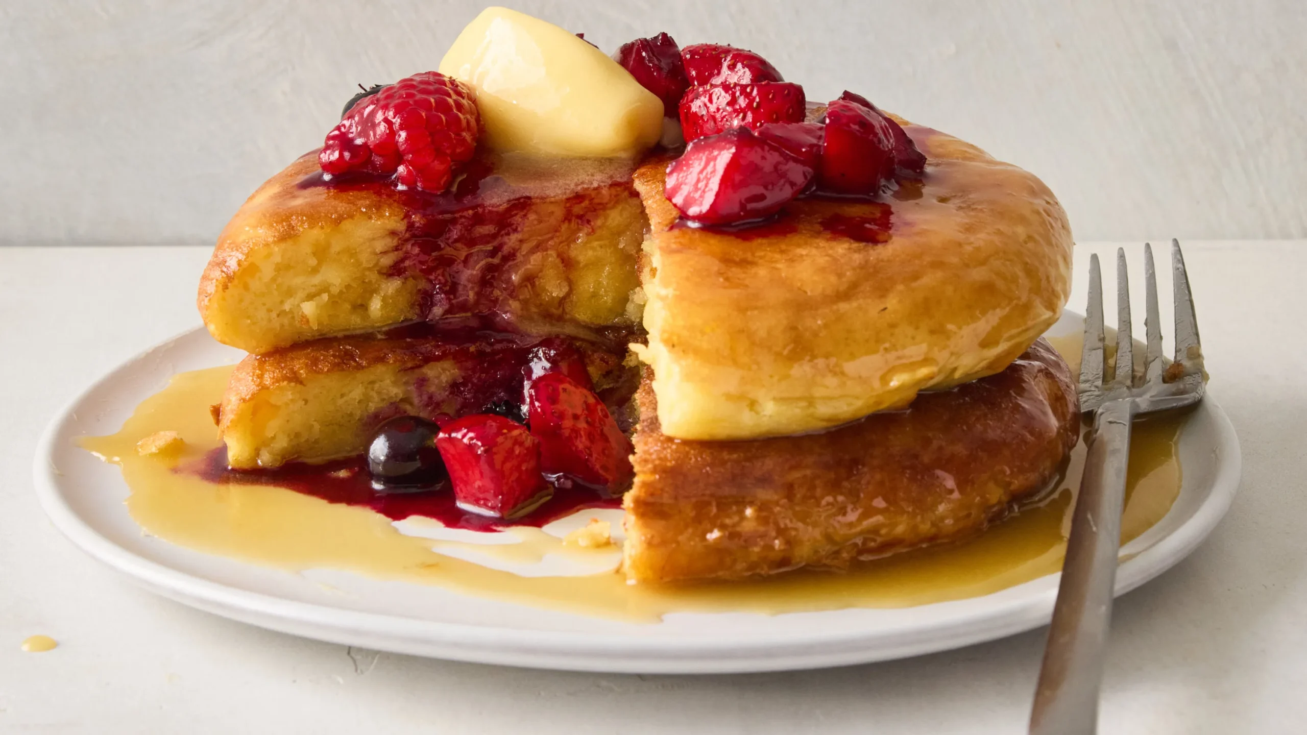 Side by side comparison of traditional and thick fluffy pancakes