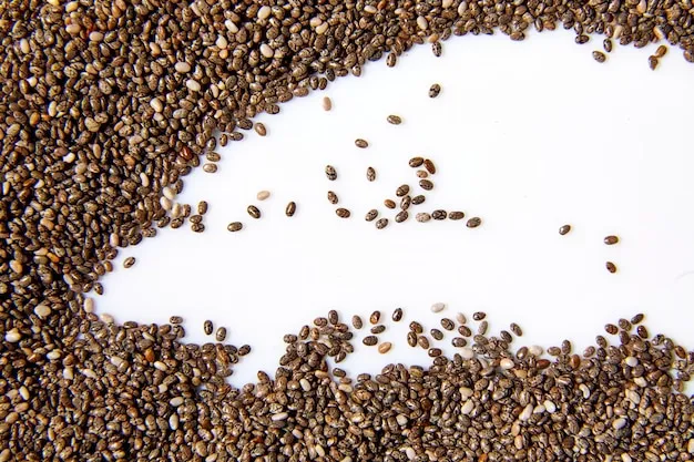 Overhead view of scattered black chia seeds and fresh whole strawberries on a rustic wooden cutting board