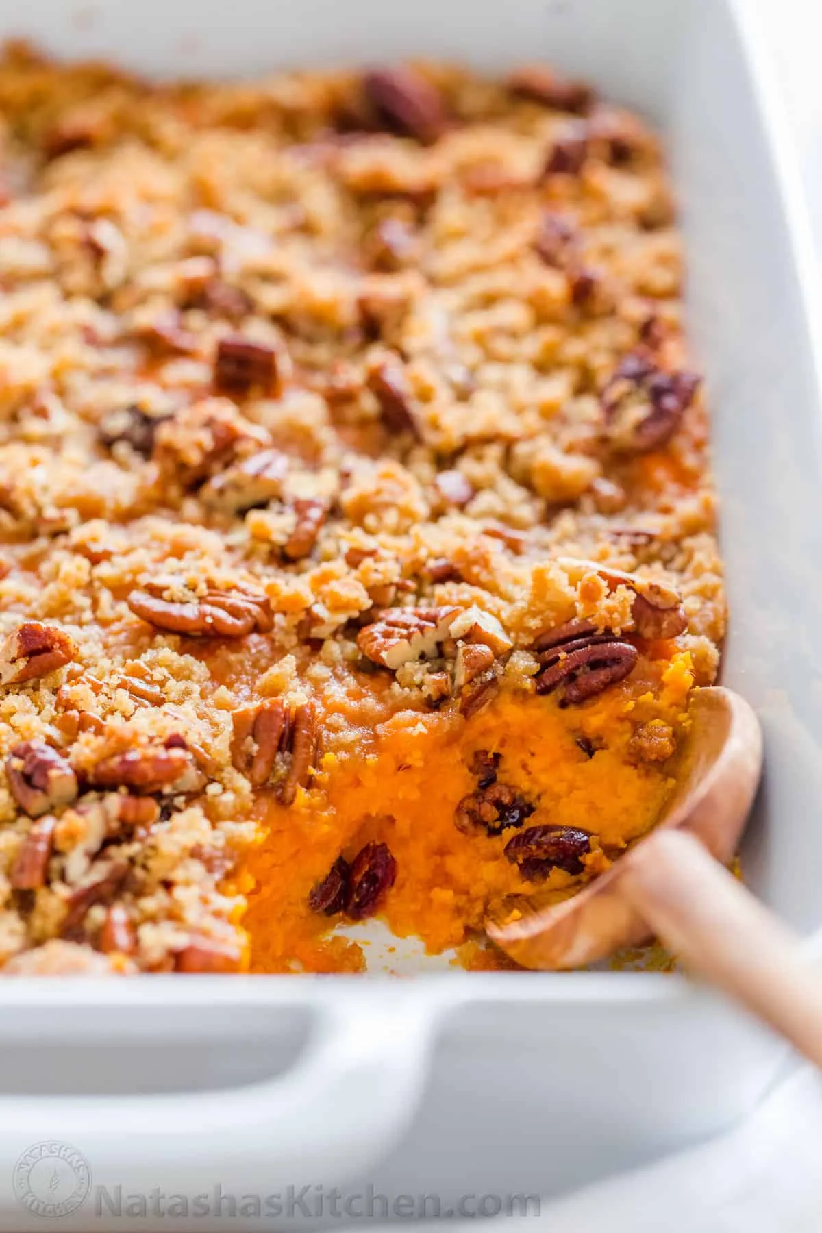 A ceramic baking dish filled with a pecan sweet potato casserole